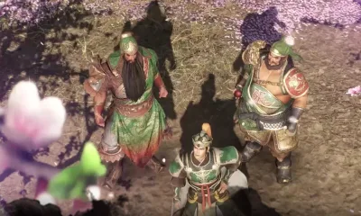 Dynasty Warriors M's three warriors in ornate armor, standing outdoors