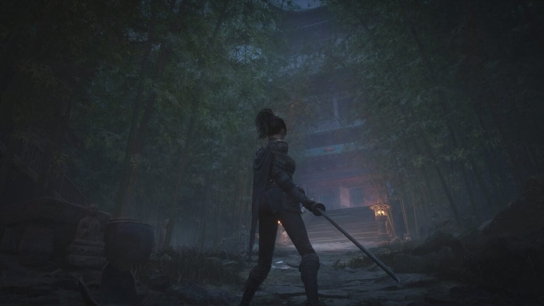 A warrior stands ready in a forest before a temple
