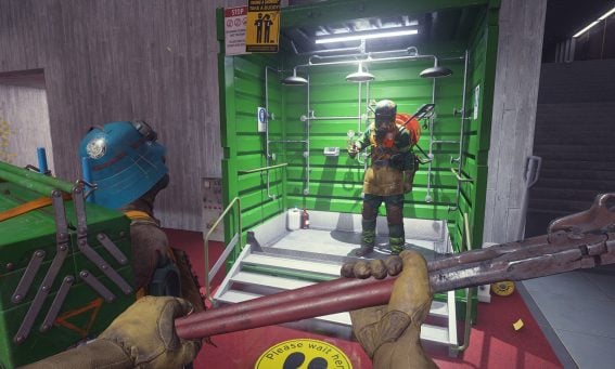 First-person view of a player in hazmat gear holding a pipe wrench, facing another suited character in Game Pass crossplay game