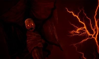 A monstrous figure with glowing eyes and sharp teeth emerges in horror mobile game