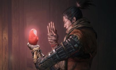 A warrior from one of the best video games of the decade studies a glowing red artifact