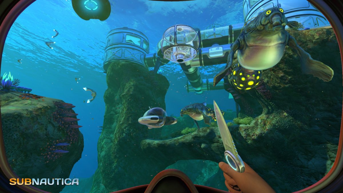 First-person view underwater near a futuristic seabase, holding a knife while glowing sea creatures swim nearby in a survival mobile game