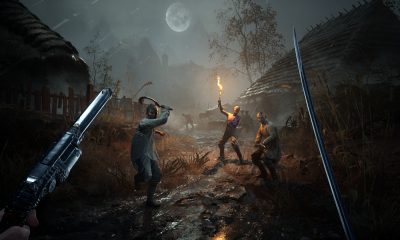 Hostile enemies bearing weapons and torches in a dark village setting