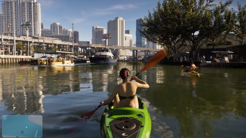 Lucia kayaks through a sunny urban waterway surrounded by boats and high-rises
