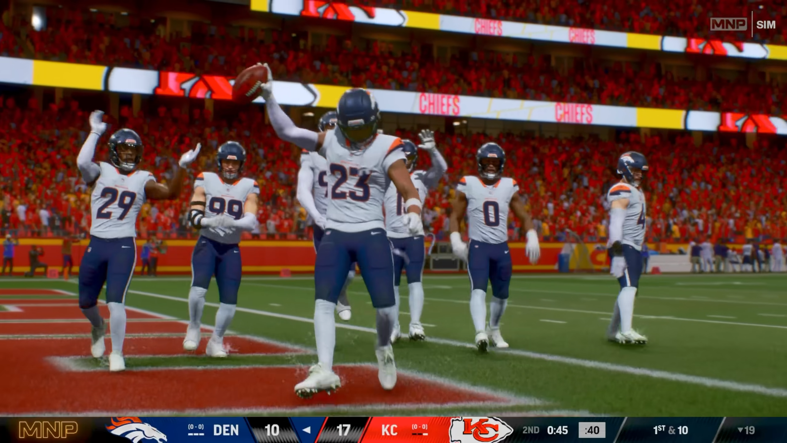 nfl player lifting ball infront of his team mates