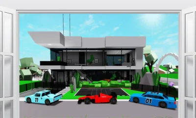 Large modern penthouse with several sports cars on driveway