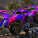 A purple and pink rocket-powered car flies above a Rocket League stadium with a bright boost trail.