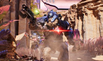 An armored alien charges through a rocky battlefield in Halo: Campaign Evolved.