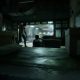 A figure sits in a dim observation room in The Outlast Trials.