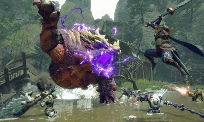 A team of hunters confronts a large purple-glowing monster in a grassy arena.