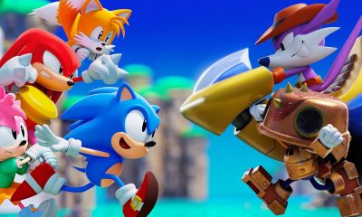 Sonic, Tails, Knuckles, and other Sonic characters gather against a bright blue sky.
