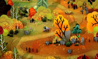 A cloaked witch walks along a winding path through an autumn forest in Wytchwood.