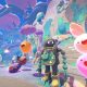 Colorful slimes leap through a bright landscape in Slime Rancher 2.