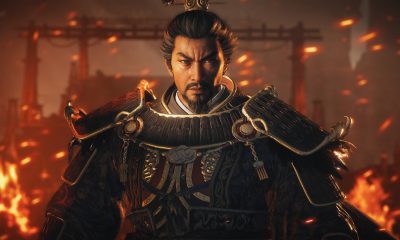 An armored warrior stands before flames in Chinese fantasy action-game artwork.