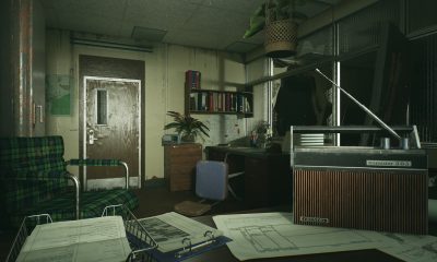 Dimly lit office with a radio and deep shadows in Still Wakes the Deep.