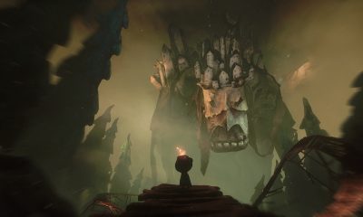 Potboy faces a towering creature crowned with miniature houses in The Midnight Walk.