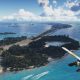 A seaplane above turquoise water, islands, and a long bridge in GTA 6's Leonida Keys
