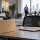 Office desk with a packed cardboard box, desk plant and closed laptop