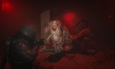 The Traveler confronts a creature in a red-lit room in Cronos: The New Dawn.
